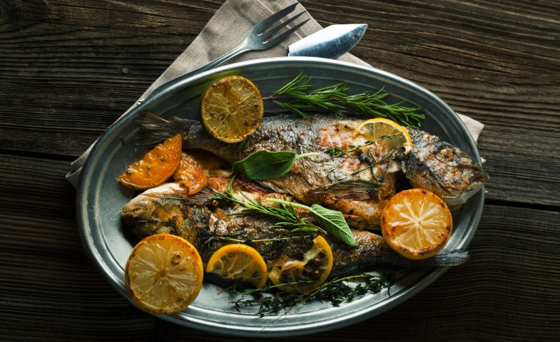 Whole grilled fish with herbs and citrus